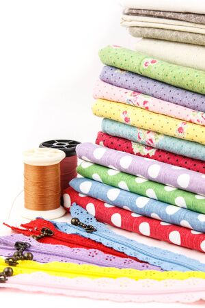 A stack of cloth and embroidery tool