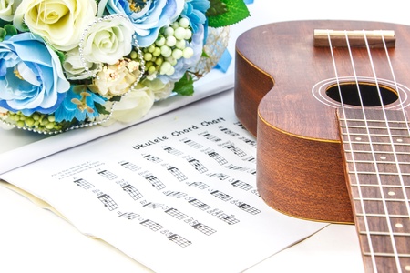 A classic ukulele,document and bunch of flower on white backgroundの写真素材
