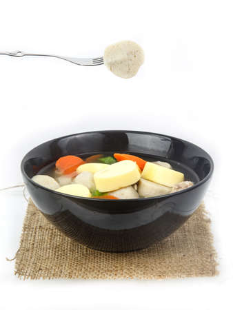 Fish ball with vegetable soup in bowl isolated on white backgroundの写真素材