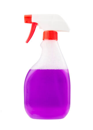 Spray bottle with violet liquid cleaner on whiteの写真素材