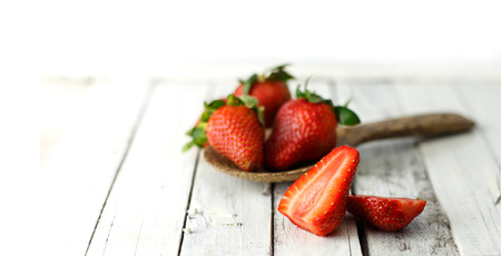 Group of fresh strawberries on white wood backgroundの写真素材