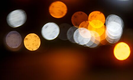Abstract bokeh background - white,yellow and orange lights at night