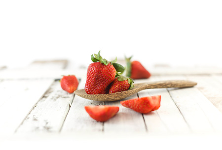 Delicious fruit - red strawberries on wooden spoonの写真素材