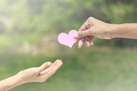 Hans give heart to another - love concept