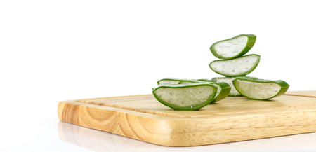 Slice aloe vera on wood against white backgroundの写真素材