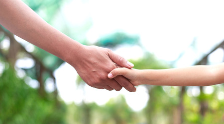 Helping hand concept -  Father hands holding daugherの写真素材