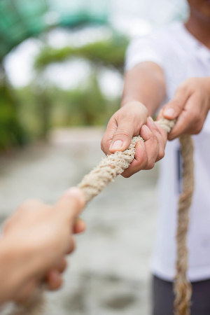 Two hands pulling rope in oppisite directionの写真素材