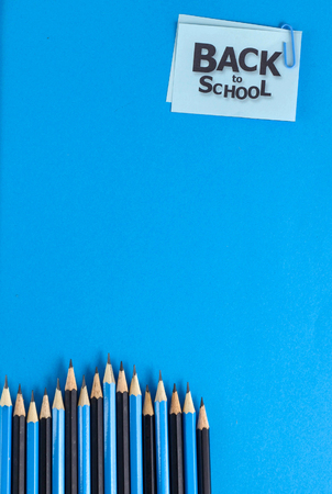 Back to school background - Pencils on blue paperの写真素材