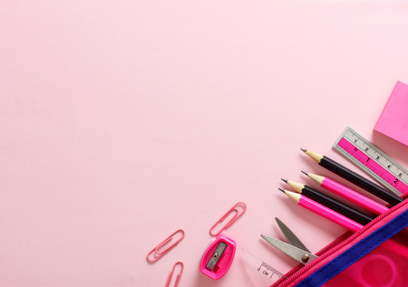 Top view Pink pencils and other stationery supplies on paper with spaceの写真素材