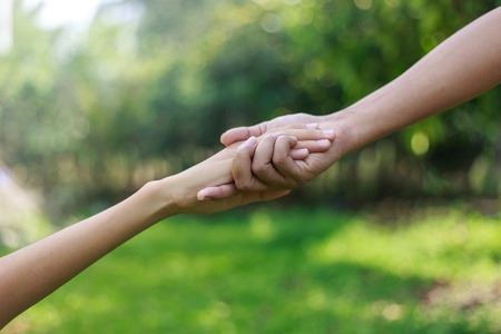 Support and helping concept - Father give helping hand to his son
