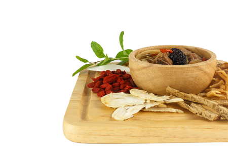 Bowl of chinese soup on wood against white backgroundの写真素材