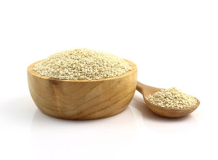 Close up - bowl of white sesame seeds on white backgroundの写真素材