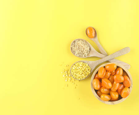 Top view of Thai dessert (Mung bean paste formed in egg yolk and sugar)  and ingredient (hulled...