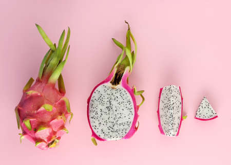 Top view of different shape of dragon fruit - full, sliced on pink backgroundの写真素材