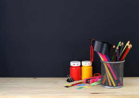 Education concept - Colorful stationery supplies such as pencil, scissor and pen on wooden table...