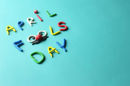 Colorful April fools day text as joker face - glasses ,red nose and mustache on green backgroundの写真素材