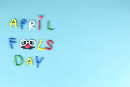 Top view of april fool day background - crayon word with smile face on blue backgroundの写真素材