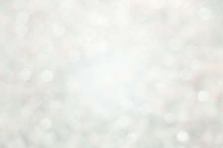 Abstract light gray and white shiny blurred bokeh bakground. Christmas template with brilliant ...