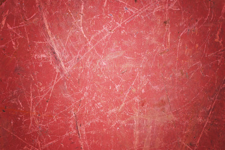 Scratch blank red grunge metal  surface as dark texture background with spot and vignette borderの写真素材