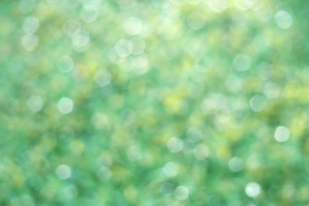 Nature green light circle bokeh abstract background with space for designの写真素材