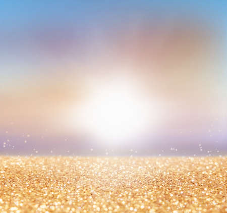 abstract of sunset, blurred-bokeh light background with golden glitterの写真素材