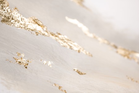 Christmas elegant background. Blurred abstract art gold foil backdrop. Luxury glamorous shiny festive soft wallpaper. Stylish, trendy and posh abstraction. Chic feminine neutral nude beige background.の写真素材