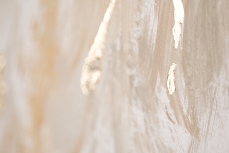 Christmas elegant background. Blurred abstract art gold foil backdrop. Luxury glamorous shiny festive soft wallpaper. Stylish, trendy and posh abstraction. Chic feminine neutral nude beige background.の写真素材