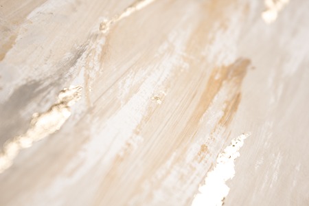 Christmas elegant background. Blurred abstract art gold foil backdrop. Luxury glamorous shiny festive soft wallpaper. Stylish, trendy and posh abstraction. Chic feminine neutral nude beige background.の写真素材