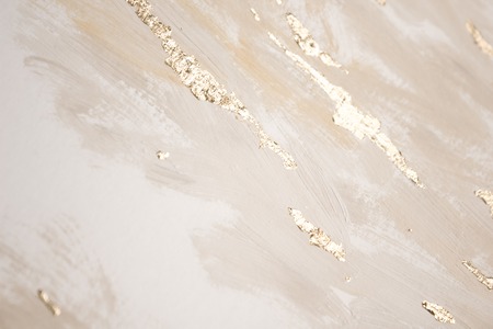 Christmas elegant background. Blurred abstract art gold foil backdrop. Luxury glamorous shiny festive soft wallpaper. Stylish, trendy and posh abstraction. Chic feminine neutral nude beige background.の写真素材