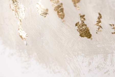 Christmas elegant background. Blurred abstract art gold foil backdrop. Luxury glamorous shiny festive soft wallpaper. Stylish, trendy and posh abstraction. Chic feminine neutral nude beige background.の写真素材
