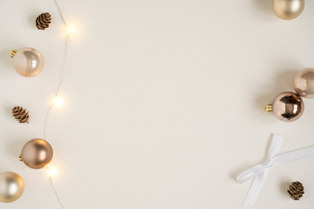 Elegant festive photo frame with blank space for text quote. Stylish flat lay copy space. Gold luxury minimalist decorations, light garland. Christmas winter cozy composition. Top desk view, lifestyleの写真素材