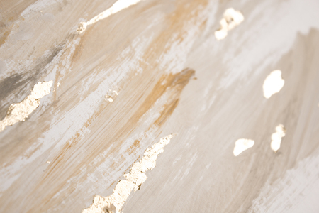 Christmas elegant background. Blurred abstract art gold foil backdrop. Luxury glamorous shiny festive soft wallpaper. Stylish, trendy and posh abstraction. Chic feminine neutral nude beige background.の写真素材