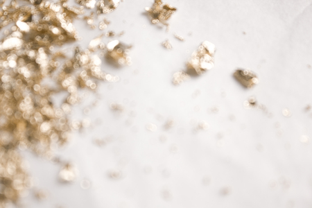 Christmas elegant background. Blurred abstract art gold glitter backdrop. Luxury glamorous shiny festive soft wallpaper. Stylish, trendy posh abstraction. Chic feminine neutral nude beige background.の写真素材