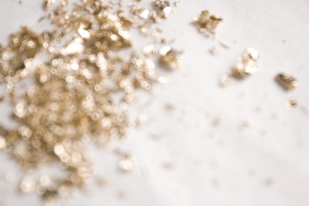 Christmas elegant background. Blurred abstract art gold glitter backdrop. Luxury glamorous shiny festive soft wallpaper. Stylish, trendy posh abstraction. Chic feminine neutral nude beige background.の写真素材