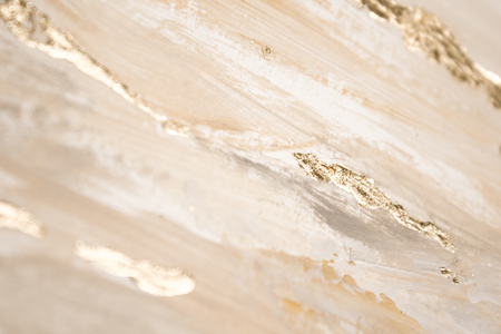 Christmas elegant background. Blurred abstract art gold foil backdrop. Luxury glamorous shiny festive soft wallpaper. Stylish, trendy and posh abstraction. Chic feminine neutral nude beige background.の写真素材