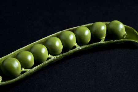 Peas on black background