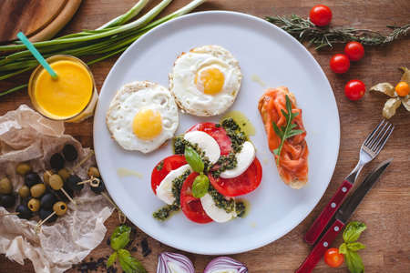 Caprese salad, eggs and sandwich with salmonの写真素材