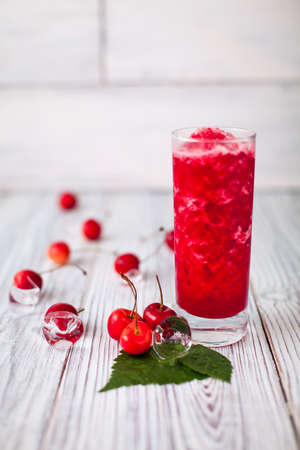 cherry juice red ice glass leaves woodenの写真素材