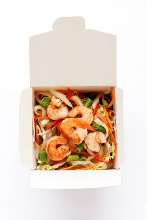 Delicious seafood wok noodles box with shrimps and udonの写真素材