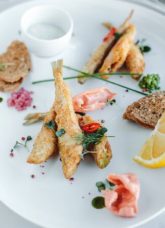 Grilled fish on plate isolated on white backgroundの写真素材