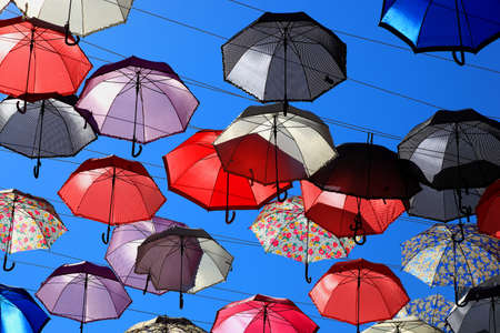 a lot of colorful umbrellas in the sky