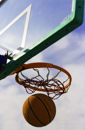 Trying to get back the basketball after a unsuccessful shot.の写真素材