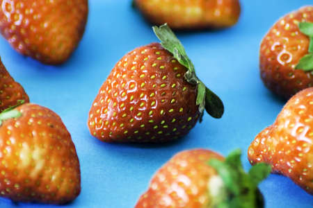 Close up of a group of fresh, succulent strawberries on the table の写真素材