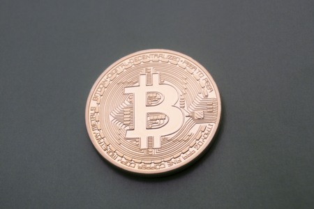 Golden Bitcoins (digital virtual money) on a black gray background.の写真素材