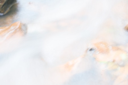 River flow, fast water flow forms a lot of foam and bubbles, abstract backgroundの写真素材