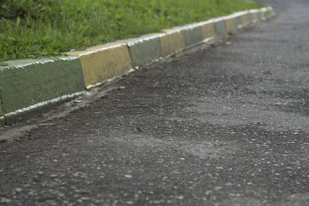 Concrete sidewalk with red and white curbの写真素材