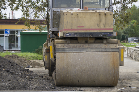 Orange road-roller on repairing of the road