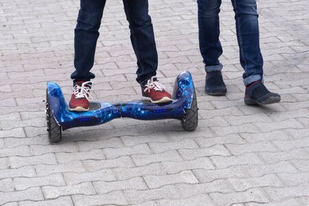 l riding on hover board or gyroscooter outdoors at sunset in summer. Active life concept