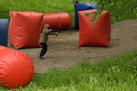 children with bows playing paintballの写真素材