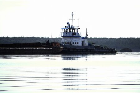 the Tug boat floats on the river